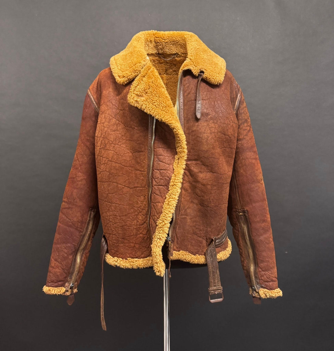 Original WWII RAF Irvin sheepskin flying jacket with honey fleece collar and brown leather panels before restoration by Revive & Restore Vintage.