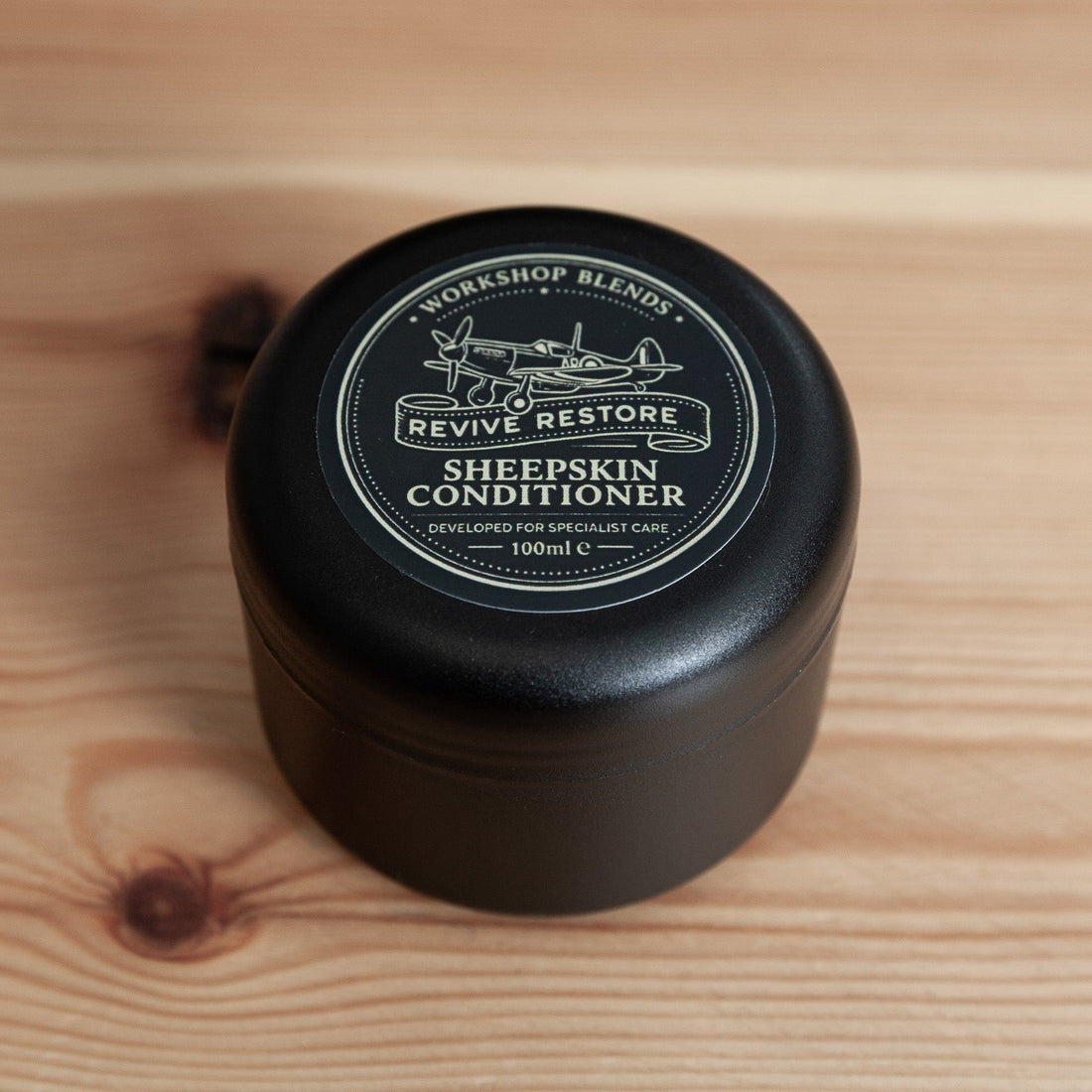 Revive & Restore Vintage Sheepskin Leather Conditioner – Workshop Blend tin on wooden surface