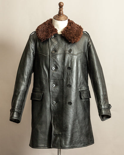 Vintage Swedish 1940s Black Goatskin leather long officers army trench coat with real wool collar on a mannequin against a beige background