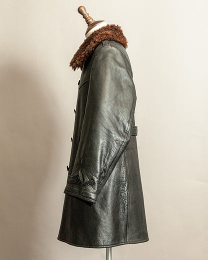 Swedish Military 1940s Black leather Trench coat with a brown wool collar on a mannequin against a beige background