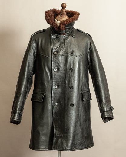 Swedish WW2 Black Goatskin leather vintage army trench coat with real wool collar on a mannequin against a beige background with the collar fastened up and wrapped high around the neck