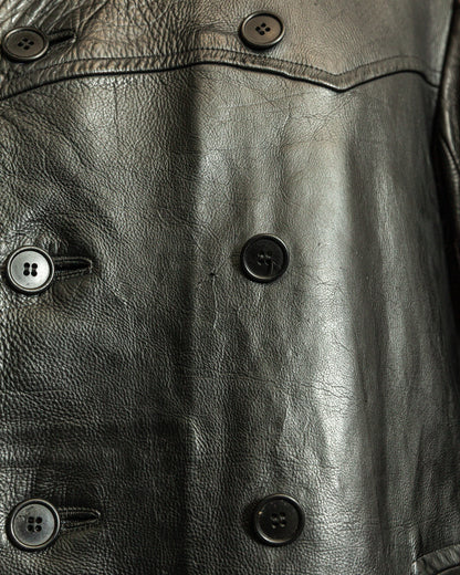 Close-up of a black leather jacket with button details