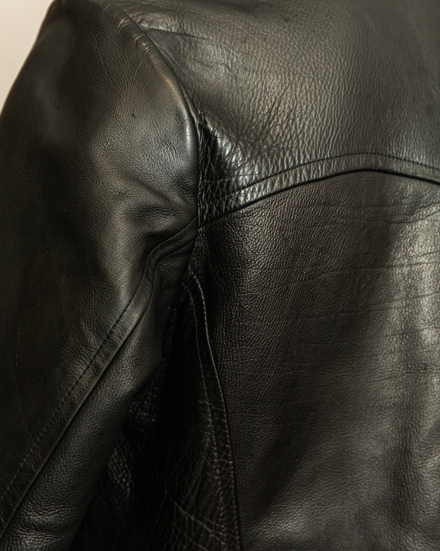 Close-up of a black leather jacket with visible stitching