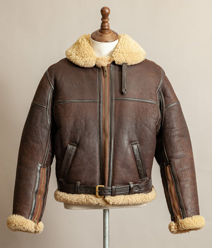 Vintage 1980s Top Stitch Irvin-pattern sheepskin flying jacket in brown leather with honey fleece – front view.