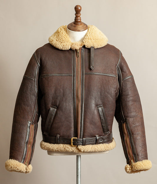 Vintage 1980s Top Stitch Irvin-pattern sheepskin flying jacket in brown leather with honey fleece – front view.