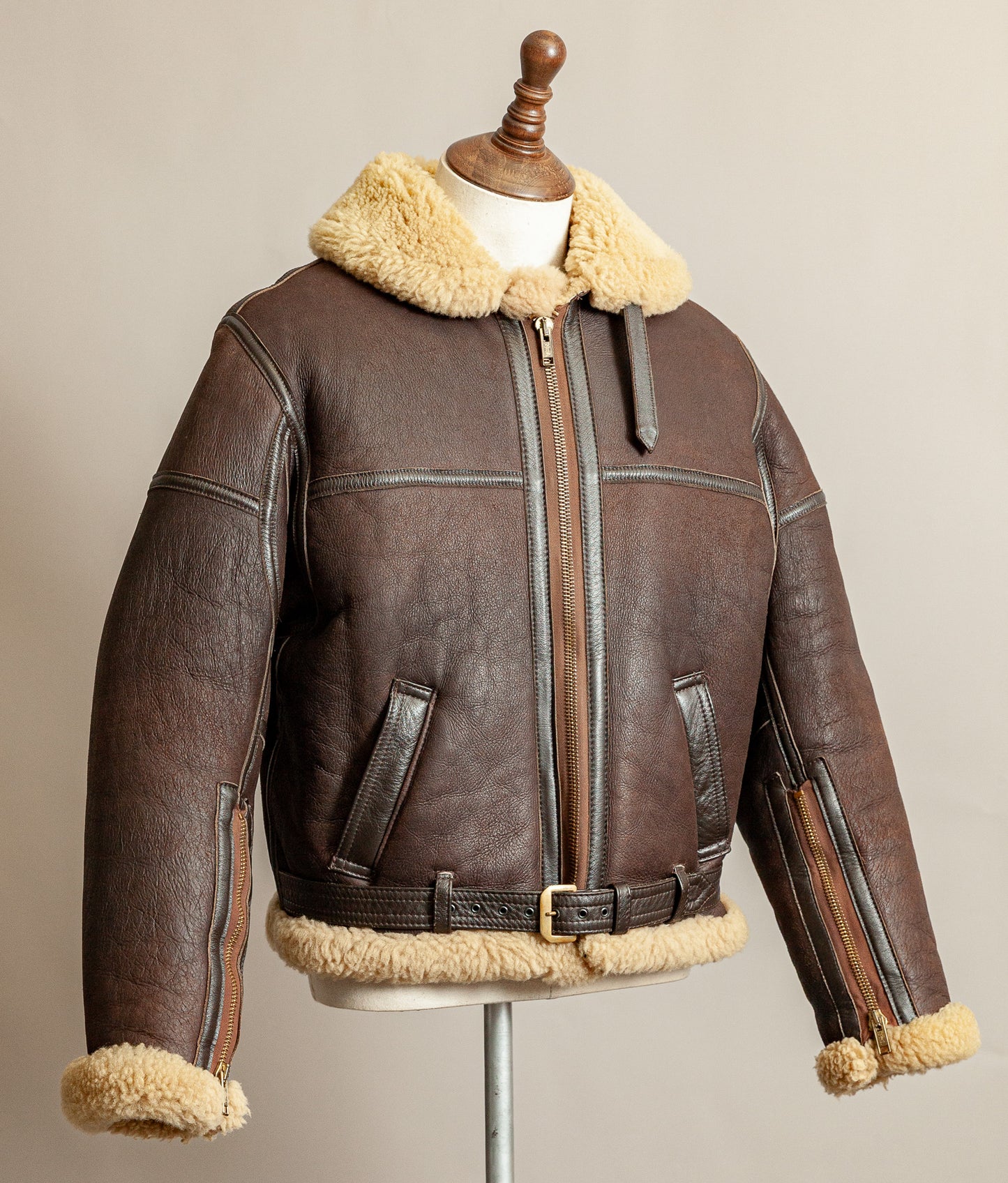 Vintage 1980s Top Stitch Irvin-pattern sheepskin flying jacket in brown leather with honey fleece – side view.