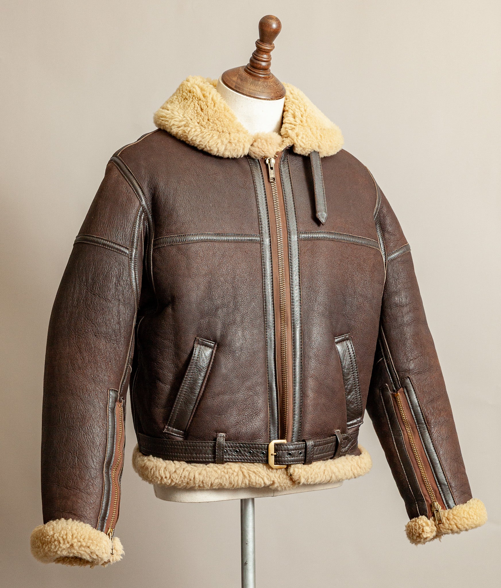 Vintage 1980s Top Stitch Irvin-pattern sheepskin flying jacket in brown leather with honey fleece – side view.