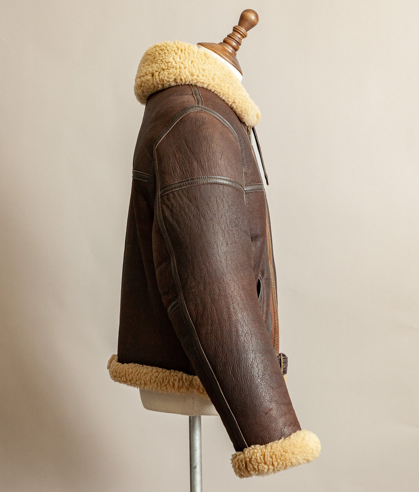 Vintage 1980s Top Stitch Irvin-pattern sheepskin flying jacket in brown leather with honey fleece – arm and side view.