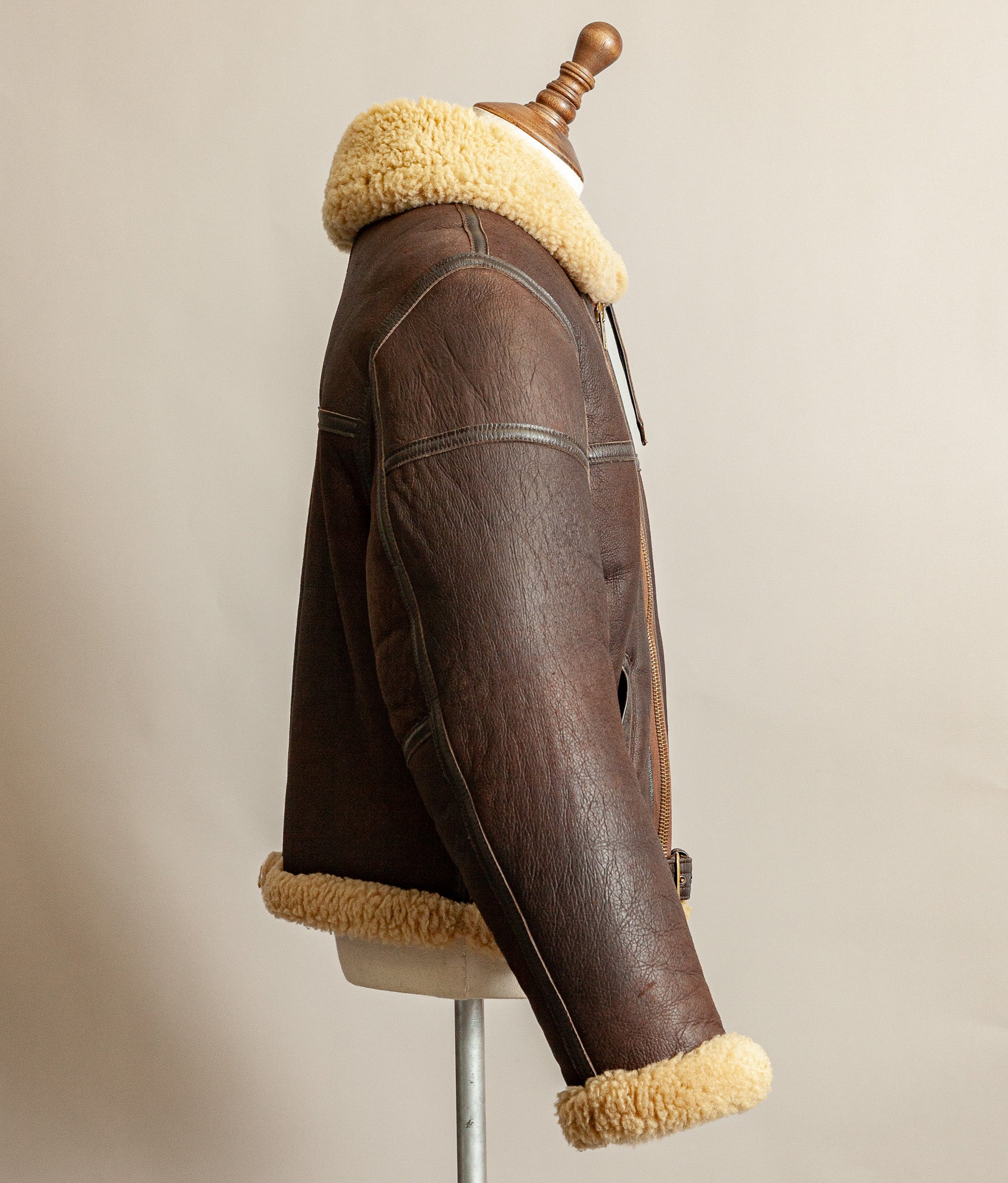 Vintage 1980s Top Stitch Irvin-pattern sheepskin flying jacket in brown leather with honey fleece – arm and side view.