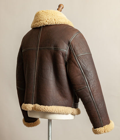 1980s Top Stitch Irvin-pattern sheepskin flying jacket – turned slight to the side, back view showing patina and seam construction.