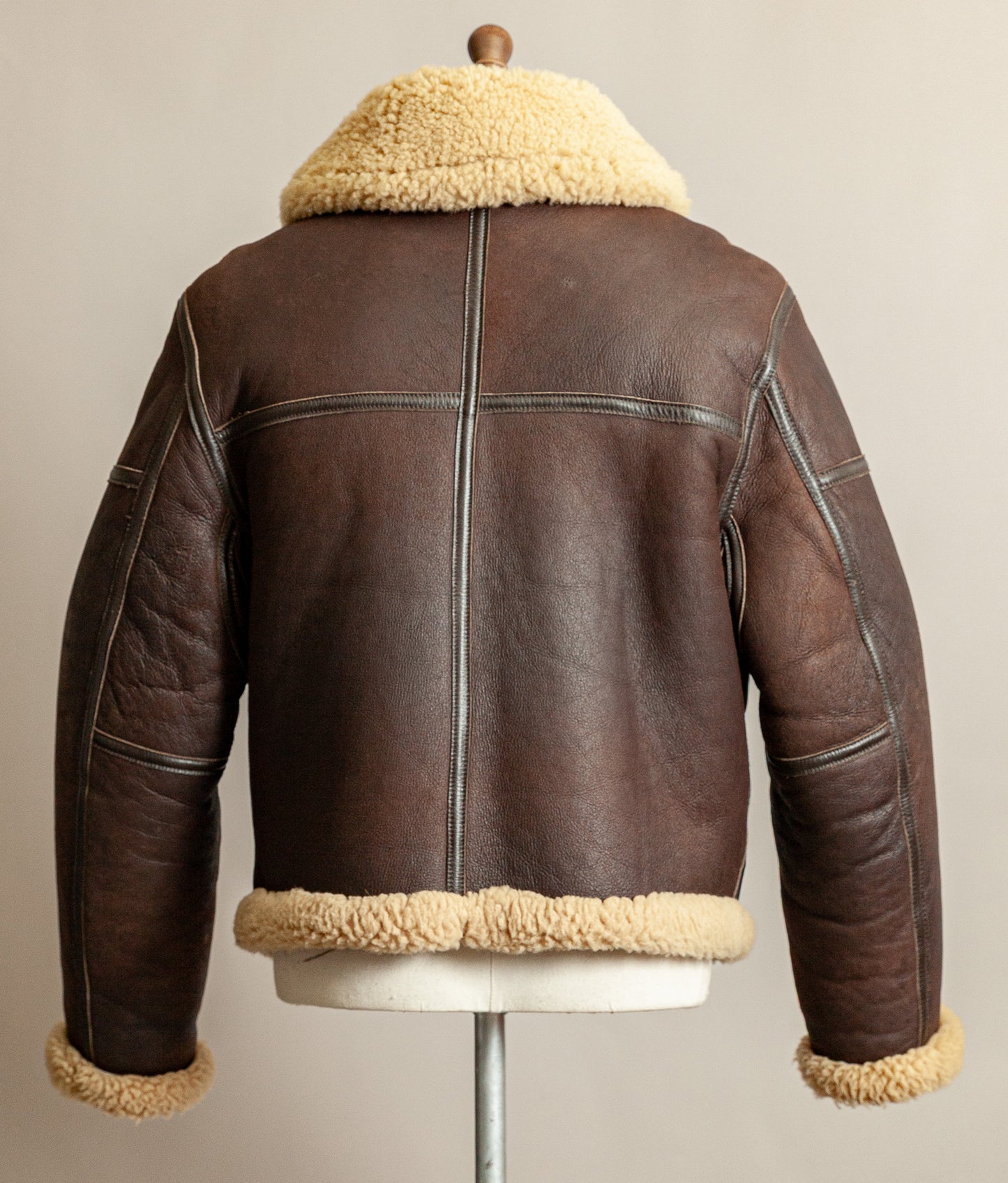 1980s Top Stitch Irvin-pattern sheepskin flying jacket – back view showing patina and seam construction.