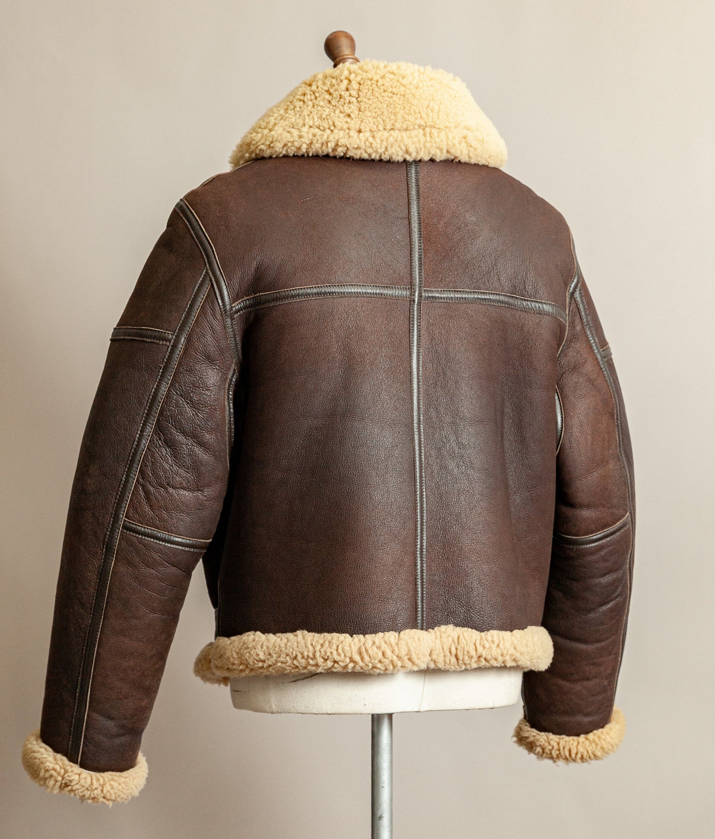 1980s Top Stitch Irvin-pattern sheepskin flying jacket – left back view showing patina and seam construction.