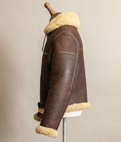 1980s Top Stitch Irvin-pattern sheepskin flying jacket – side view left arm showing patina and seam construction.