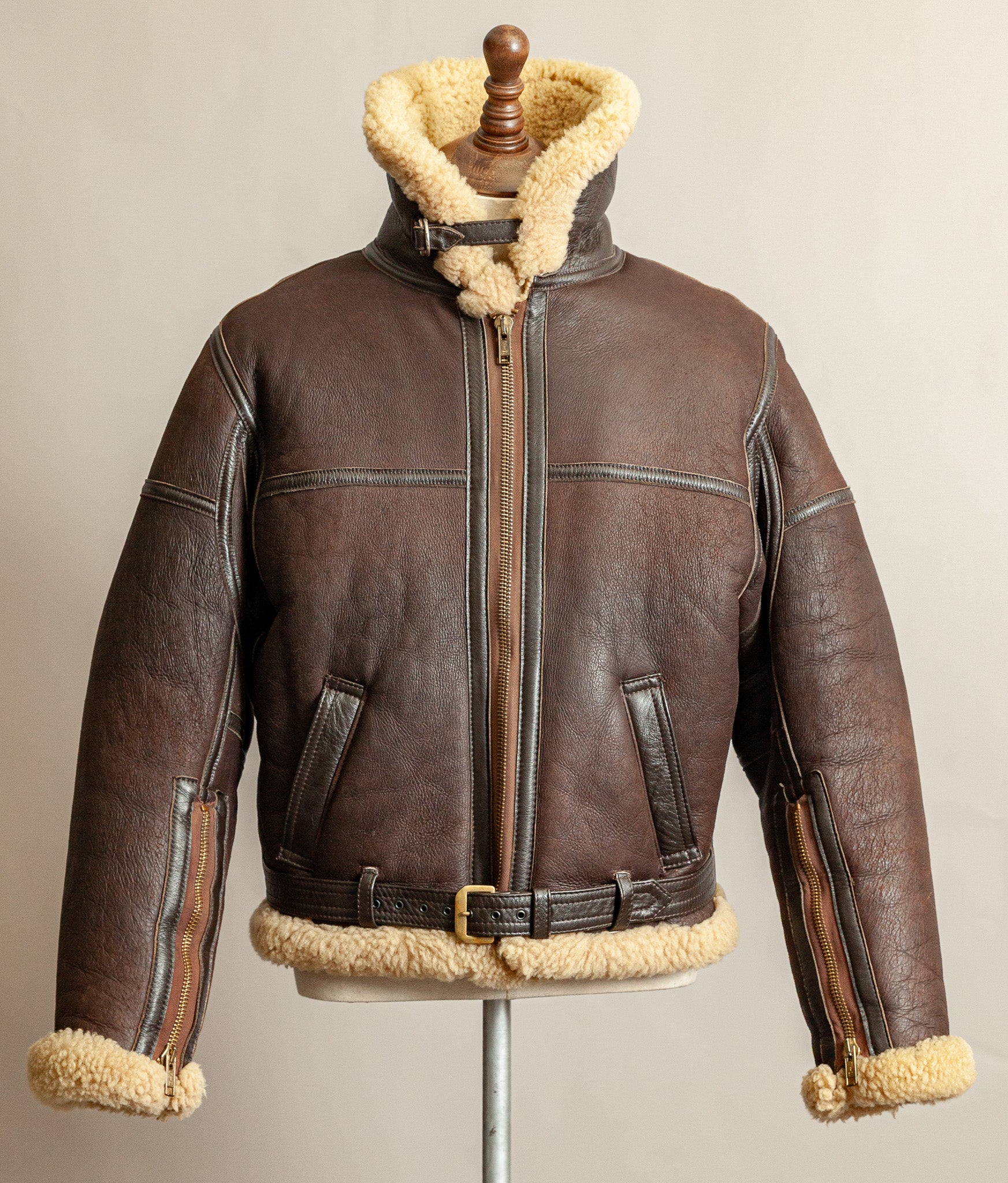 1980s Top Stitch Irvin-pattern sheepskin flying jacket – front view with collar fastened and standing high, showing patina and seam construction.