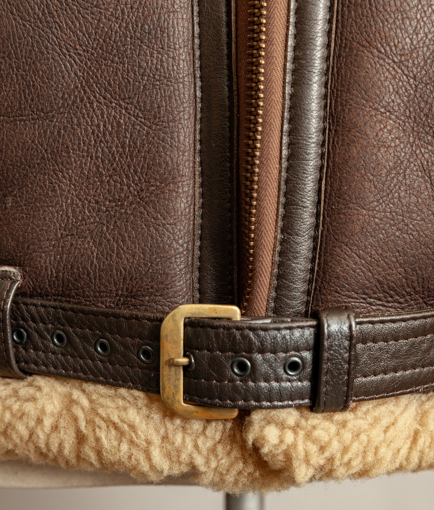 Brass RAF Irvin belt buckle and stitching details of the belt, the colour is dark brown and brass