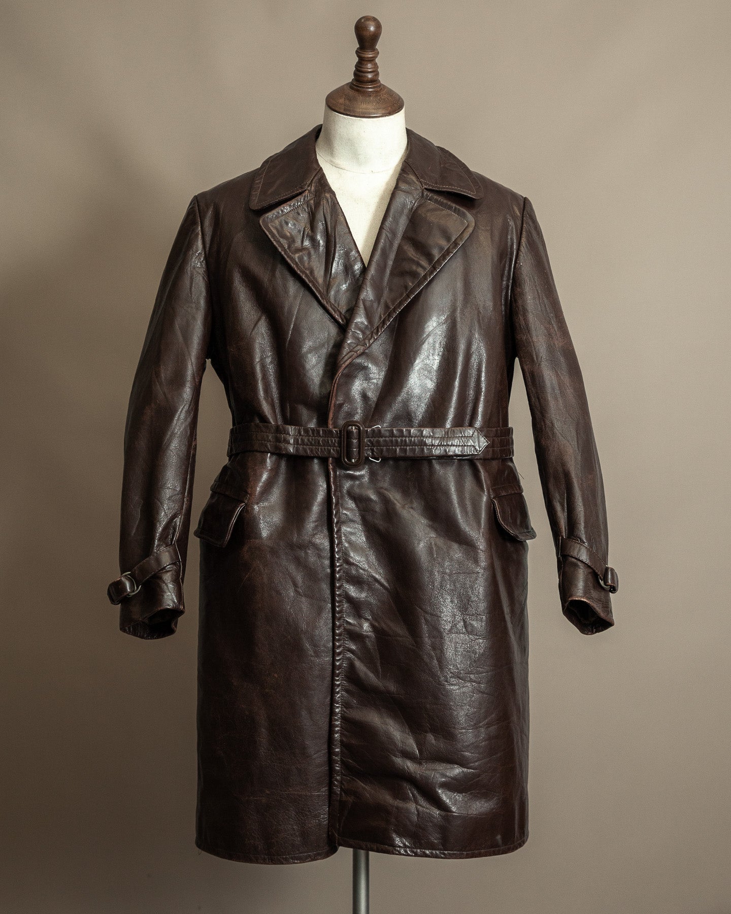 Late 1940s Cold War Czechoslovak horsehide leather coat with full belt, heavy patina, front view on dress form