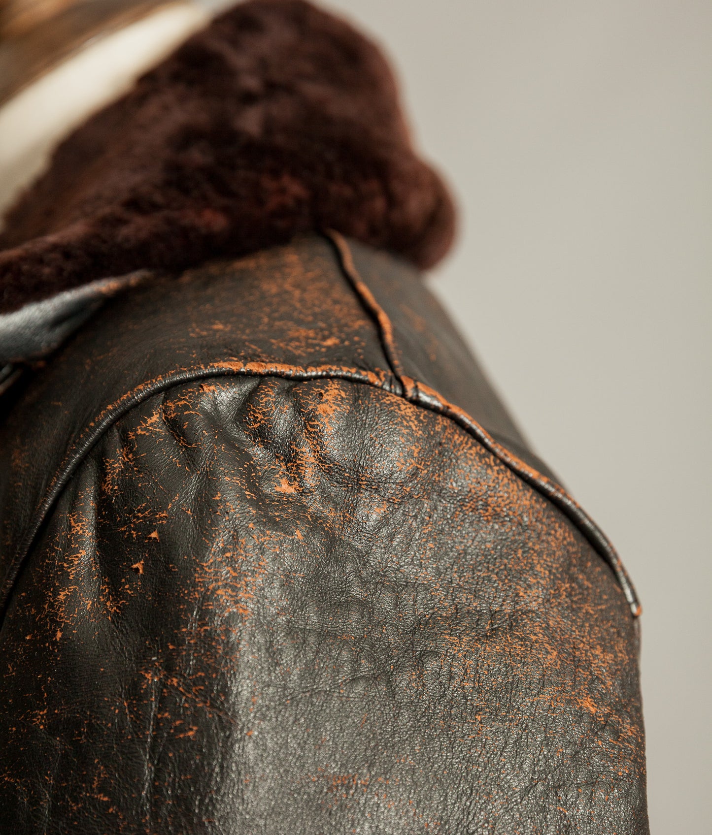 Close up of tea core leather wear on vintage French leather jacket shoulder