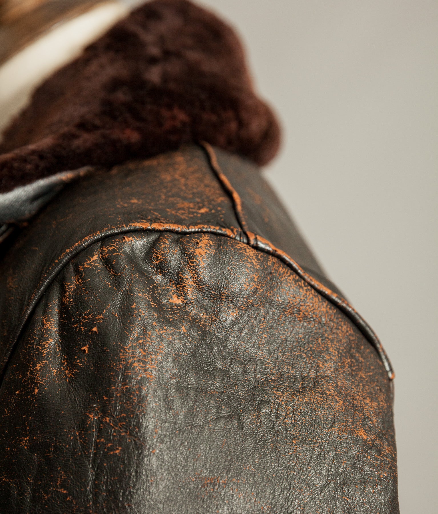 Close up of tea core leather wear on vintage French leather jacket shoulder