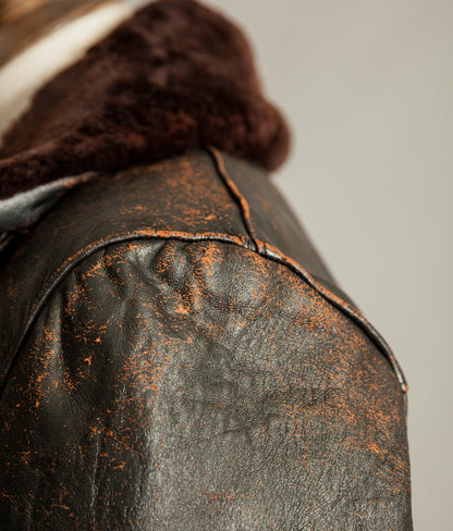 Close up of tea core leather wear on vintage French leather jacket shoulder