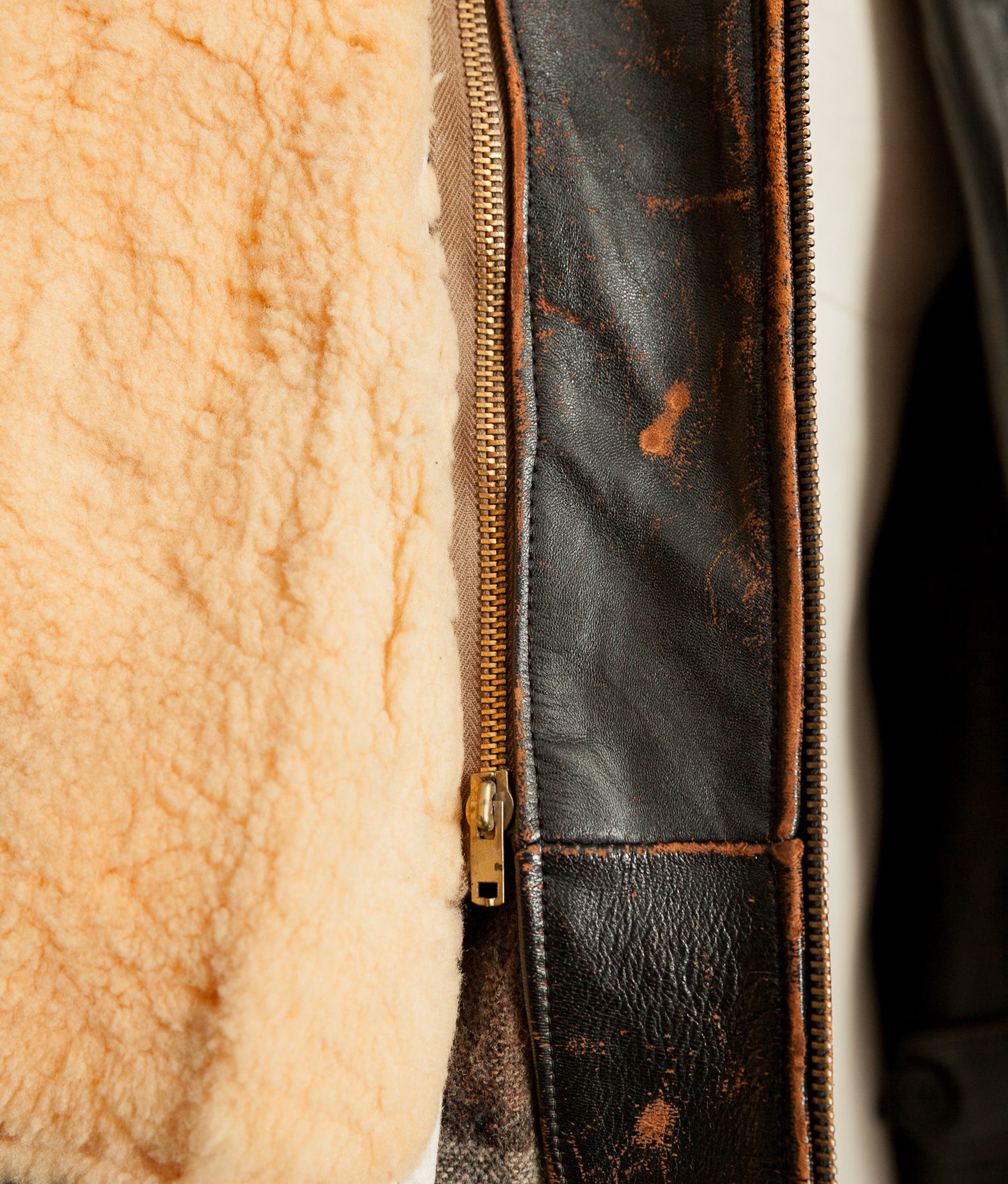 Close-up of a jacket with fur lining and leather zipper