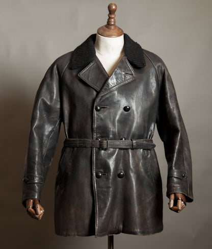 Vintage Italian double-breasted goatskin police motoring coat with knitted wool collar and belt, displayed on a wooden mannequin