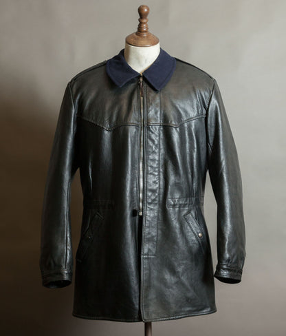 Front of a vintage 1960s Swedish military t/50 black goatskin leather coat by Joel Jonsson, with navy wool collar, zip front and shoulder straps