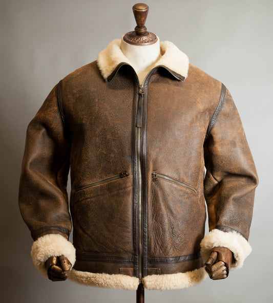 Front view of vintage Dolce & Gabbana lambskin shearling aviator jacket in distressed tobacco brown with cream fleece collar and cuffs