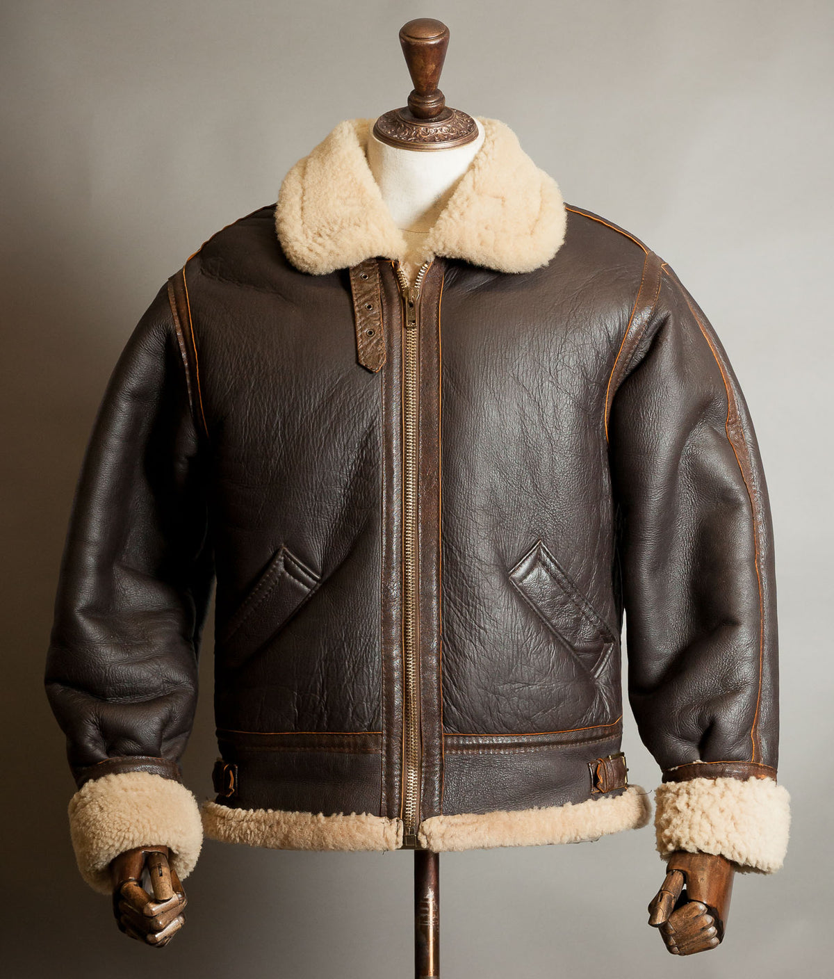 Front view of vintage 1970s sheepskin B-3 flying jacket in chocolate brown with cream shearling collar, cuffs and hem, made in England