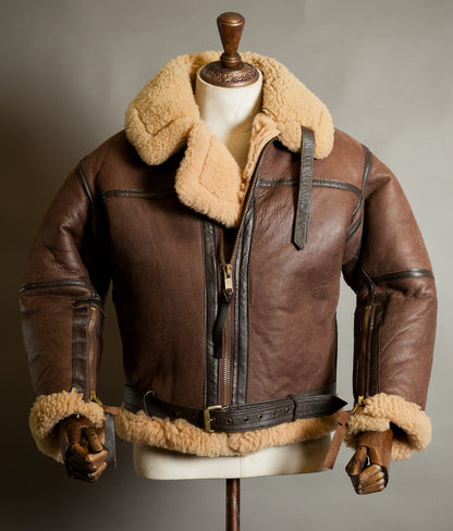 Front view of Irvin sheepskin flying jacket by Aviation Leathercraft in brown with honey shearling collar, cowhide-bound seams and IRVIN belt